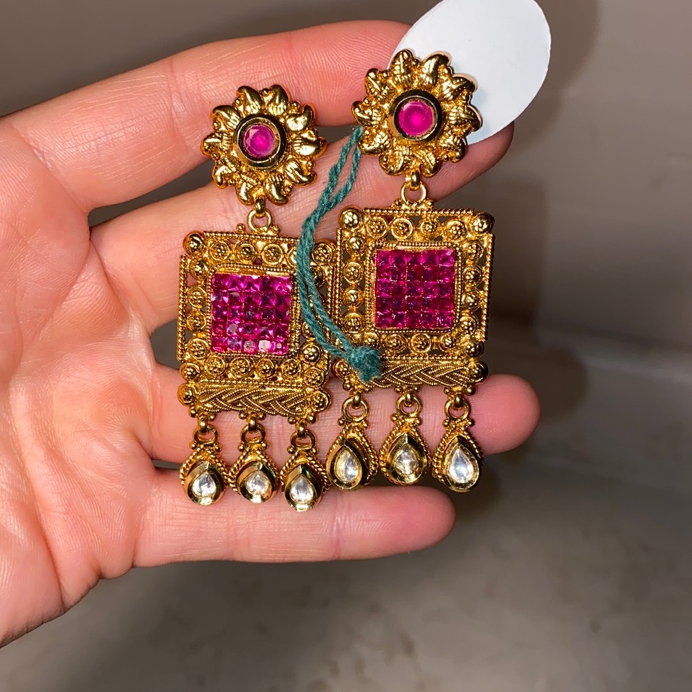 Gold dangling earrings with red gems brand new